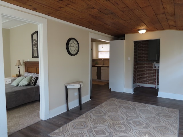 spare room with wooden ceiling, vaulted ceiling, dark wood-type flooring, and sink