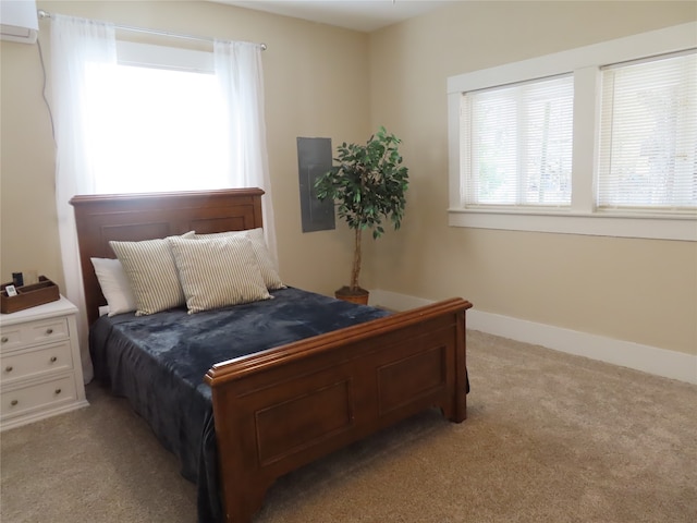 carpeted bedroom with an AC wall unit