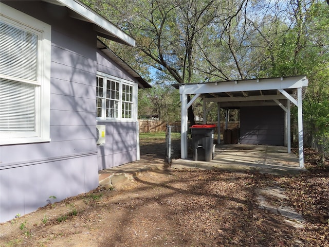 view of side of home with a carport