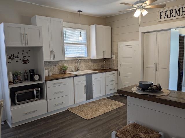 kitchen with white cabinets, wood counters, dark hardwood / wood-style flooring, and sink