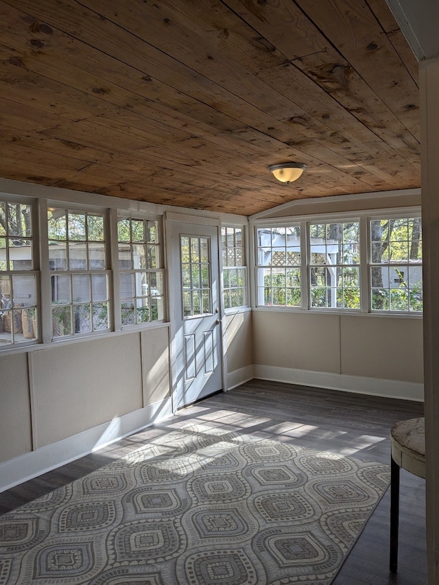 unfurnished sunroom featuring a healthy amount of sunlight, lofted ceiling, and wood ceiling