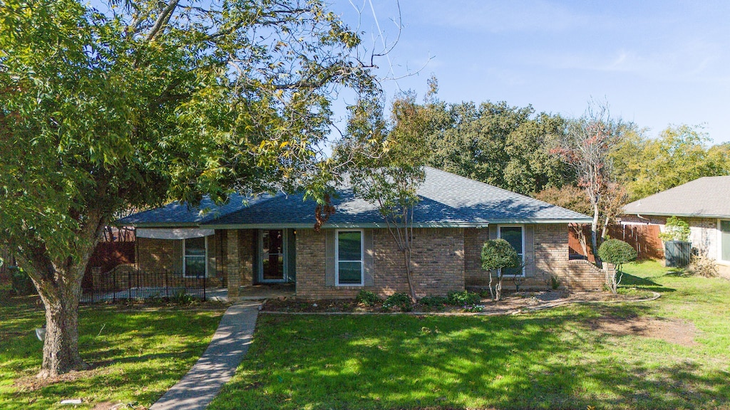 ranch-style house with a front lawn