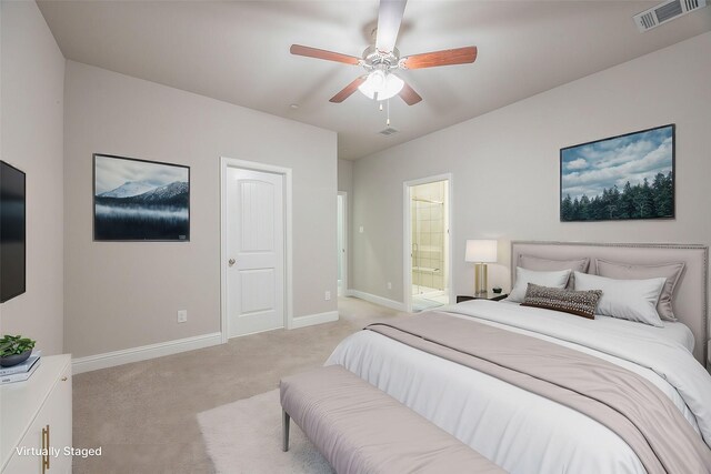 bedroom with light carpet, connected bathroom, and ceiling fan