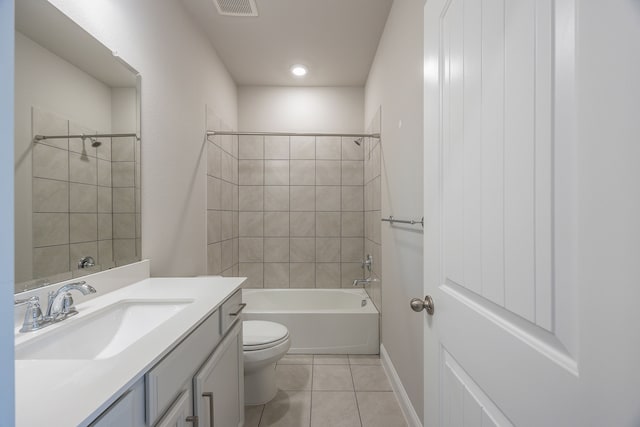 full bathroom featuring tile patterned flooring, vanity, toilet, and tiled shower / bath