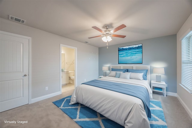 bedroom with connected bathroom, ceiling fan, and light carpet