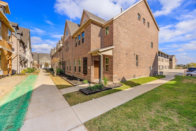 321 Baker Dr, Plano, TX 75074 - view of side of home with brick siding, a residential view, and a lawn