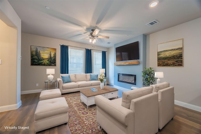 321 Baker Dr, Plano, TX 75074 - living area featuring baseboards, a ceiling fan, a glass covered fireplace, wood finished floors, and recessed lighting