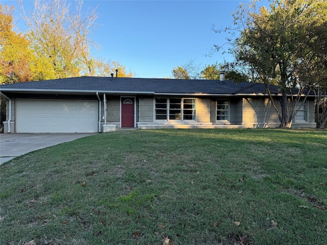 single story home with a garage and a front lawn