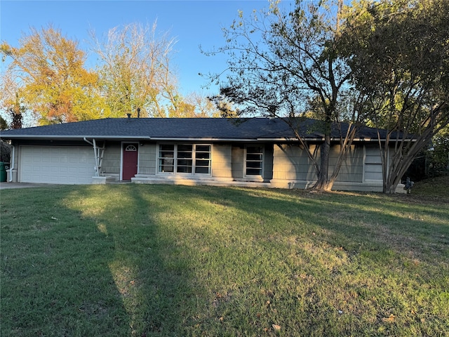 ranch-style house with a front yard and a garage