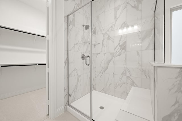 1540 Euclid Aly, Corinth, TX 76208 - bathroom with a marble finish shower, a walk in closet, and tile patterned flooring