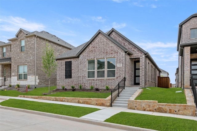 1540 Euclid Aly, Corinth, TX 76208 - view of front facade featuring brick siding and a front yard