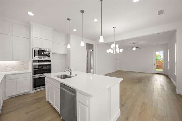 1540 Euclid Aly, Corinth, TX 76208 - kitchen featuring a sink, appliances with stainless steel finishes, recessed lighting, light wood finished floors, and white cabinets