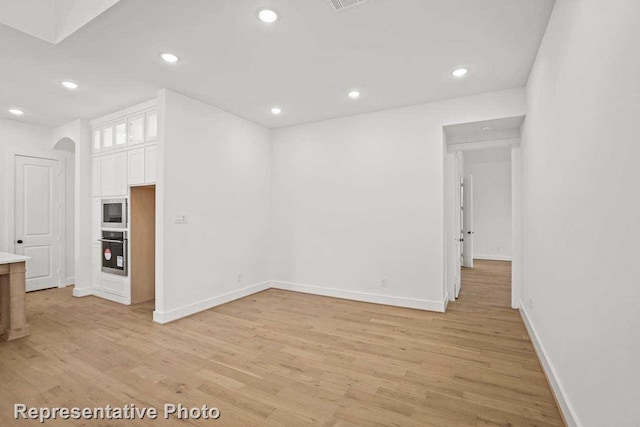 unfurnished living room featuring light hardwood / wood-style floors