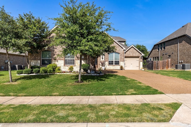 view of front of house with central AC unit, a front yard, and a garage