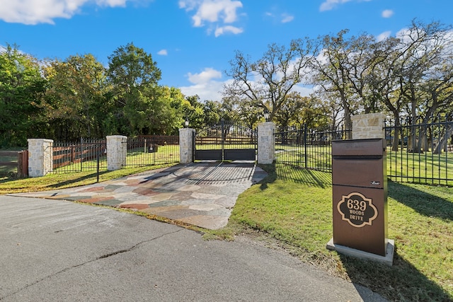 view of gate featuring a yard