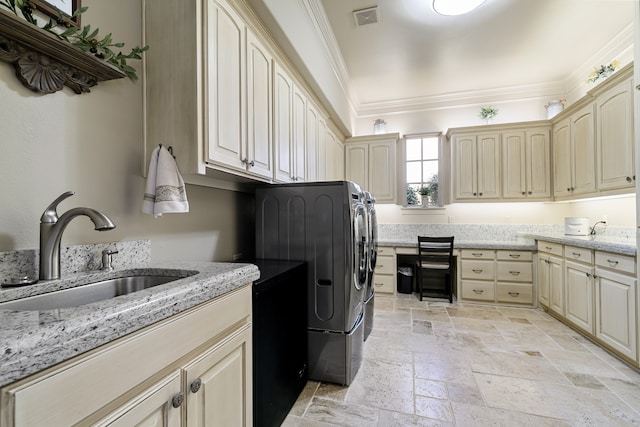 laundry room with washer and clothes dryer, crown molding, cabinets, and sink