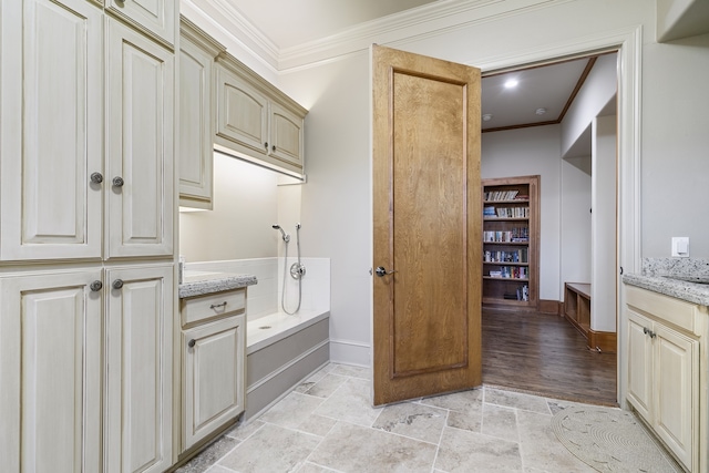 bathroom with crown molding, hardwood / wood-style floors, and vanity