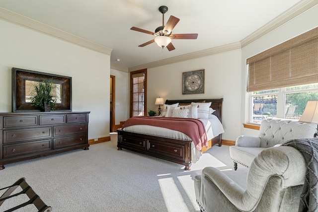 bedroom with light colored carpet, ceiling fan, and crown molding