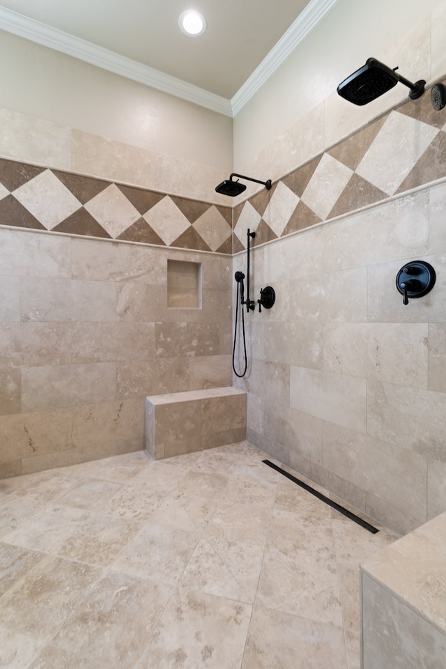 bathroom featuring a tile shower and crown molding