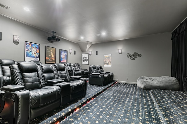 cinema with carpet flooring and crown molding