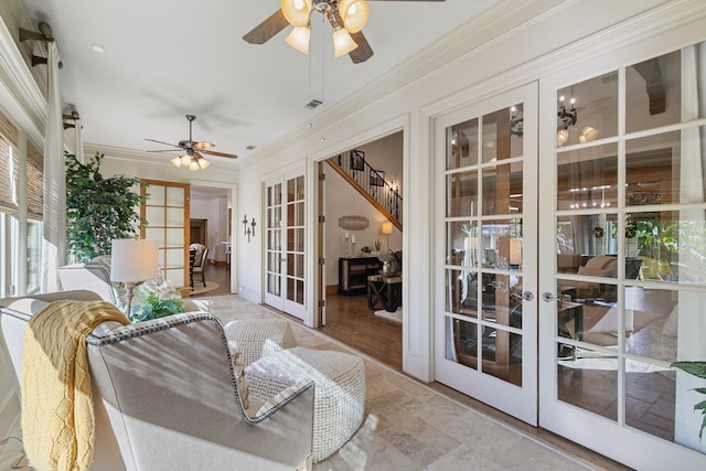 sunroom featuring ceiling fan and french doors