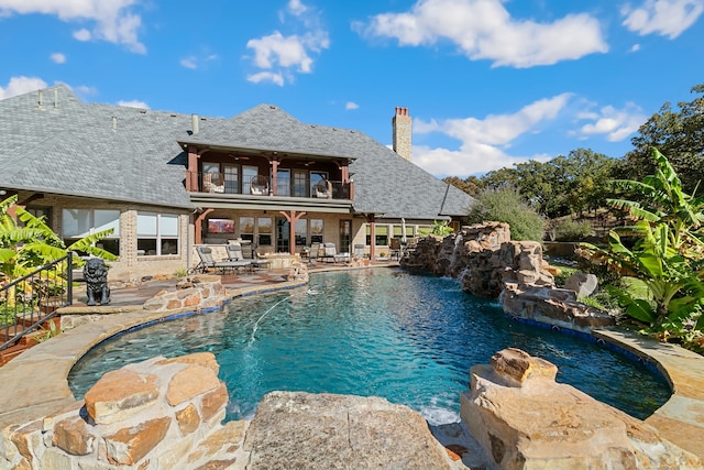 view of swimming pool with a patio area and pool water feature