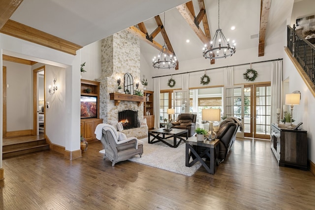 living room featuring beam ceiling, french doors, dark wood-type flooring, a stone fireplace, and high vaulted ceiling