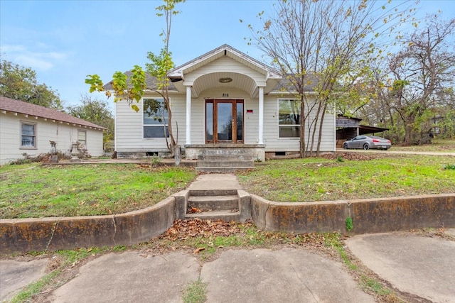 bungalow-style home featuring a front yard