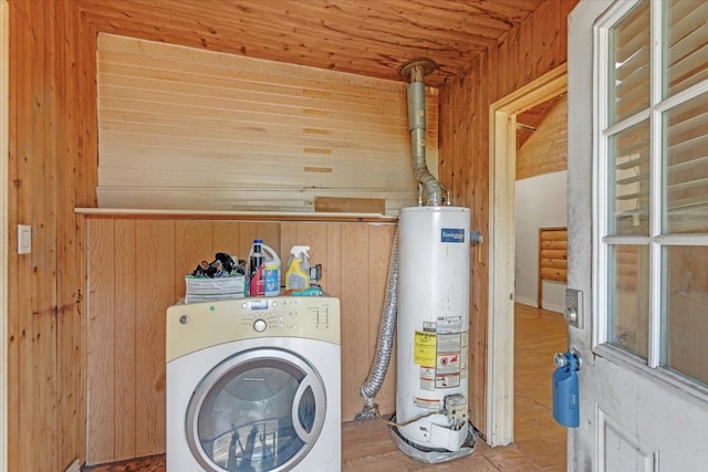 clothes washing area with gas water heater, hardwood / wood-style floors, washer / dryer, wooden walls, and wood ceiling