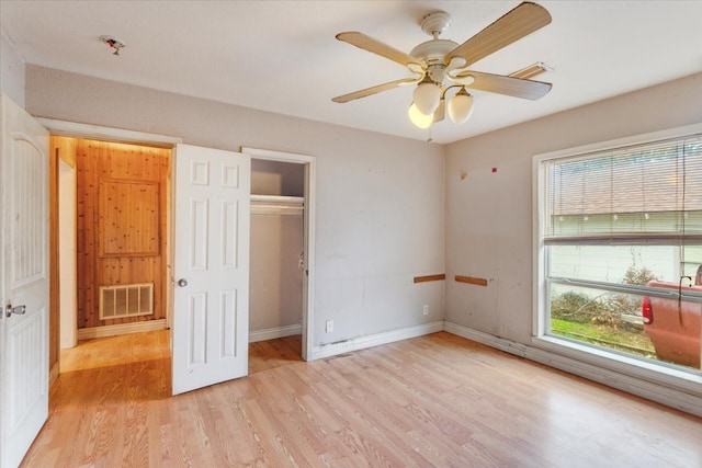 unfurnished bedroom featuring light wood-type flooring and ceiling fan