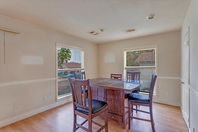 dining area with plenty of natural light and light wood-type flooring