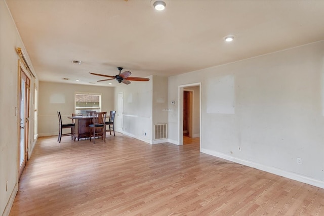 unfurnished dining area with ceiling fan and light hardwood / wood-style flooring