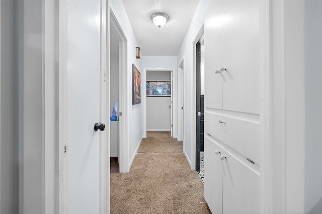 hall with light colored carpet