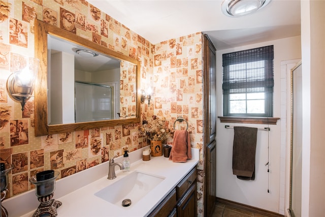 bathroom featuring tile patterned flooring, vanity, and a shower with door