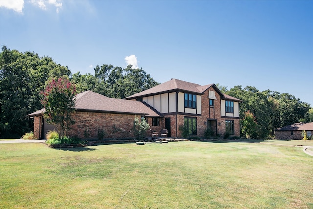 english style home featuring a front yard