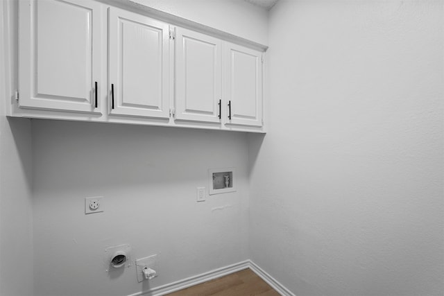 laundry room with electric dryer hookup, cabinets, gas dryer hookup, hookup for a washing machine, and wood-type flooring