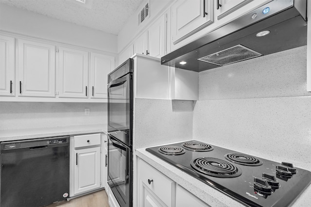 kitchen featuring black appliances, decorative backsplash, white cabinets, and a textured ceiling