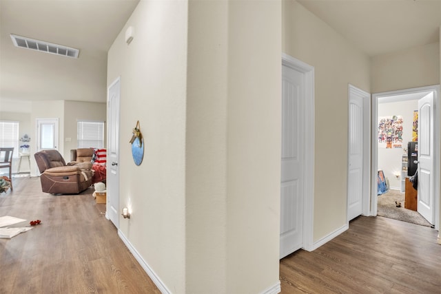 hallway with hardwood / wood-style floors