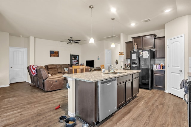 kitchen featuring black refrigerator with ice dispenser, sink, stainless steel dishwasher, hardwood / wood-style flooring, and dark brown cabinetry