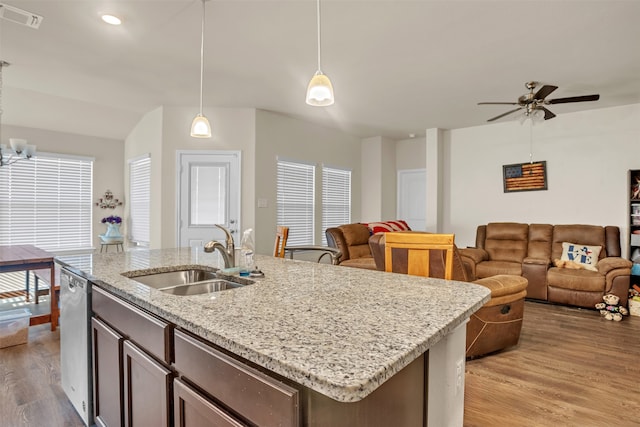 kitchen with decorative light fixtures, plenty of natural light, light wood-type flooring, and sink