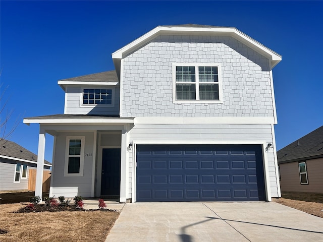 view of front of property featuring a garage and concrete driveway