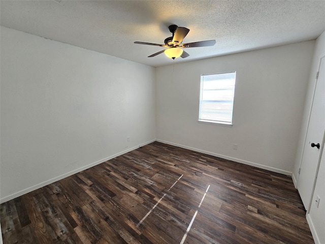 unfurnished room with ceiling fan, dark wood-type flooring, and a textured ceiling