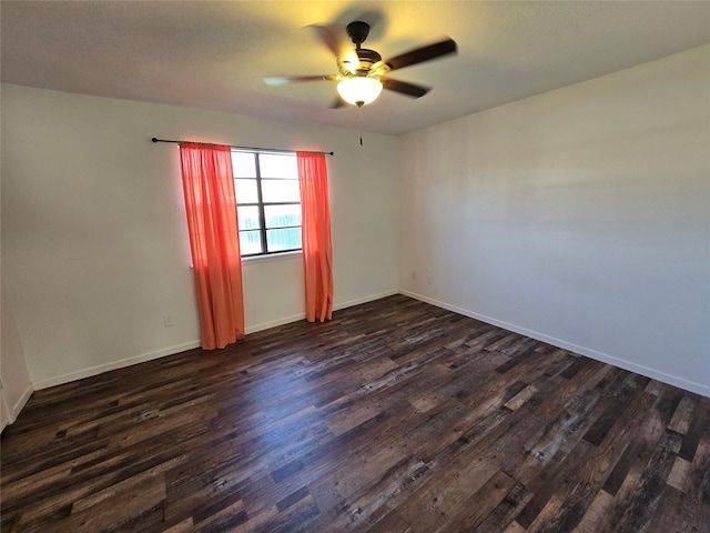 unfurnished room with ceiling fan and dark hardwood / wood-style floors