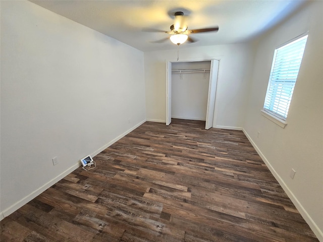 unfurnished bedroom featuring a closet, ceiling fan, and dark wood-type flooring