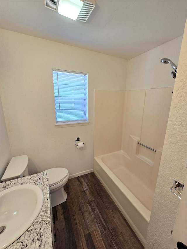 bathroom with sink, toilet, and hardwood / wood-style flooring