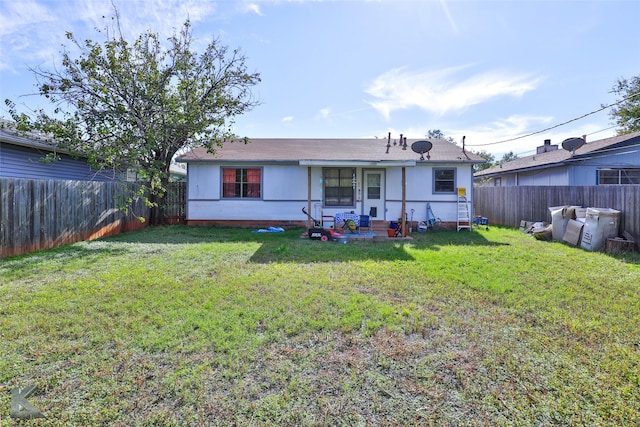 back of house featuring a yard