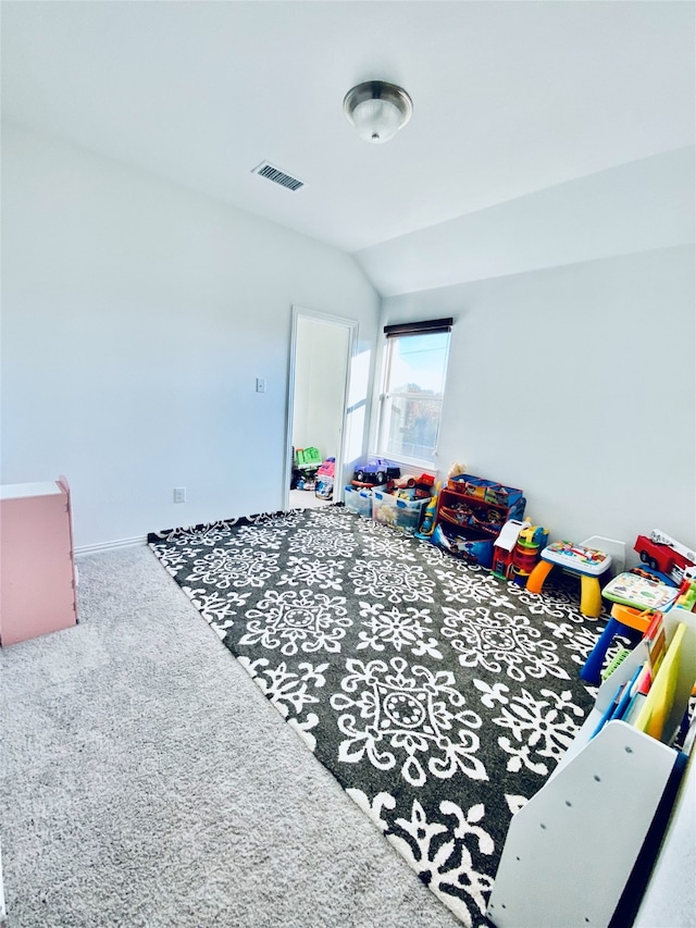 carpeted bedroom featuring vaulted ceiling