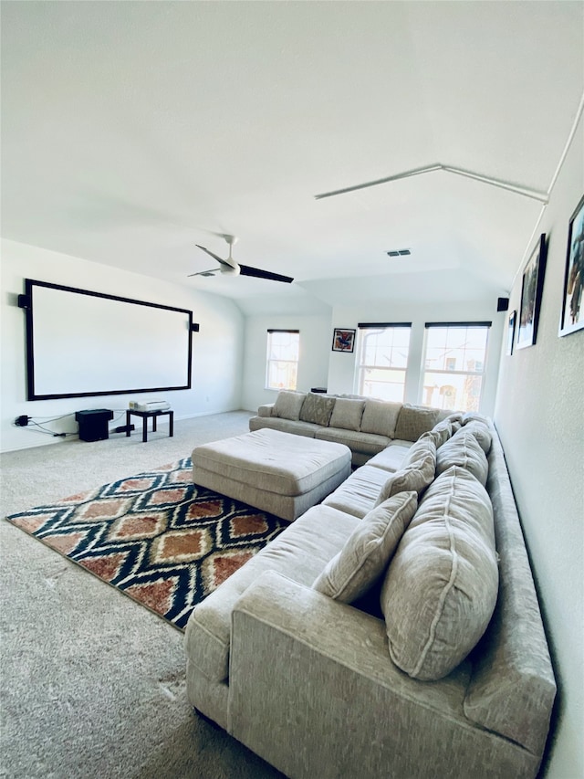 carpeted cinema room with lofted ceiling, ceiling fan, and a healthy amount of sunlight