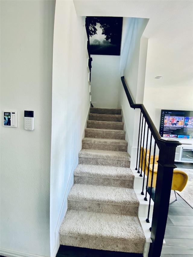 staircase featuring wood-type flooring