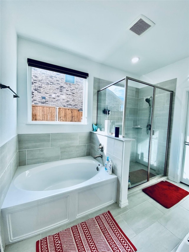 bathroom featuring separate shower and tub and tile patterned floors